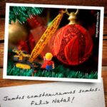 Cartão de Natal para empresas de engenharia e construção com imagem de boneco vestindo roupa de operário de construção civil decorando árvore de Natal.