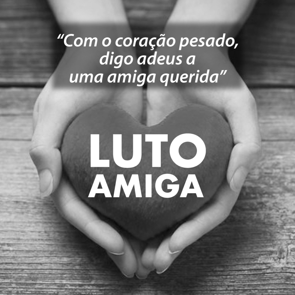 Imagem de luto por uma amiga com a foto de uma mãos segurando delicadamente um coração com a frase "luto amiga". Há uma mensagem com palavras de despedida e carinho